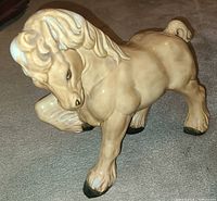Left side view of tan ceramic horse figurine