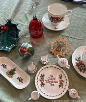 Full lot overhead showing dishware, ornaments, bell, holly dish