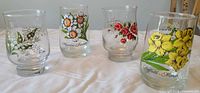 Front view of four tumblers showing floral graphics