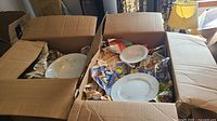 Two cardboard boxes containing wrapped Garden Fantasy china pieces