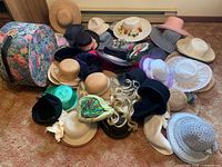 Top view of mixed hats, floral hatbox, blonde wig