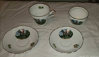 Overview of teacup, sugar bowl and two saucers with RCMP design
