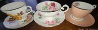 Three teacup and saucer sets side by side