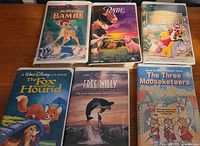 Front covers of six VHS tapes laid out on table