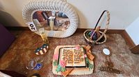 Overview showing wicker mirror, bible verse plaque, basket and several small items