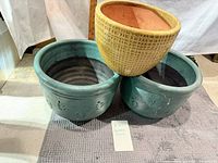 Two teal and one yellow ceramic planters