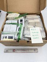 Open box showing multiple zipper bags and bundles of mounted slides with paper note marked "K62 Vintage 35MM slides"