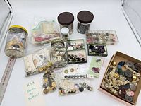 Overview of lot showing multiple jars, bags, boxes and cards of buttons