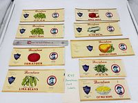 Overview of nine Burnham labels arranged with ruler for scale