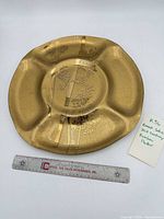 Full view of platter next to ruler for scale