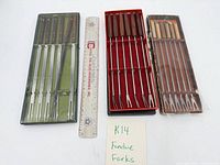 Three boxed fondue fork sets with ruler for scale