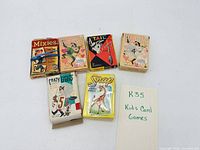 Five card game boxes and lot label displayed
