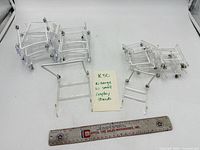 Grouped view of all clear acrylic display stands, ruler for scale