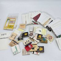 Overview of assorted matchbooks and covers spread out on table
