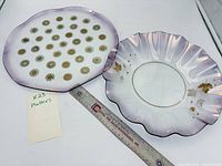 Both platters beside 12 in. ruler showing size and designs