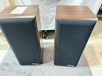 Front view of both Polk Audio speakers with grilles