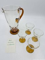 Pitcher with four glasses displayed