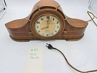 Full view of wooden electric mantel clock with cord
