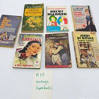 Seven paperback books laid out showing front covers