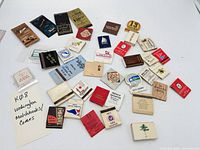 overview of entire lot of matchbooks laid out on white background