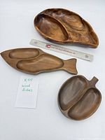 Overview of the three wood dishes with ruler for scale