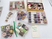 Overall view of two spool cases and bags of wooden spools