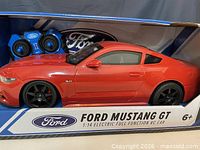 Front view of boxed red Ford Mustang GT RC car and controller