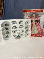 Overall view of boxed Barbie doll beside tray of tea set pieces