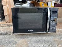 Front view of Emerson microwave showing window, handle, control panel