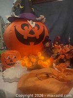 Overall lot showing inflatable pumpkin, witch hats, lights, ghost figurine, jack-o-lantern decor