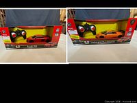 Both boxed RC cars side-by-side showing fronts and controllers