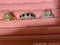 Three rings displayed on pink ring tray, full front view