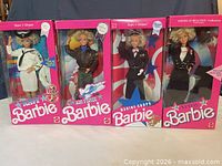 Front view of all four boxed dolls