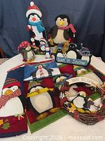 Group shot of all penguin decorations, towels, wreath and sign