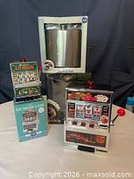 Group showing both slot machine banks and boxed oversized flask