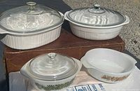 Front view of all four dishes and three lids
