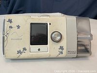 Front view showing LCD, dial, buttons, humidifier chamber