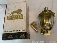 Box showing Savoy House branding beside lantern and hardware