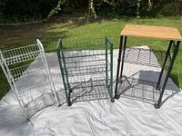 Front view of three wire shelving units showing colors, wood tops and shelves