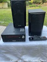 main unit, two speakers, remote control front view