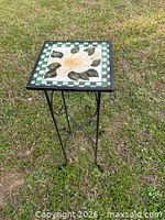 Full view of plant stand showing wrought iron base and floral ceramic tile top