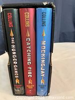 Spines of all three hardcover books in slipcase