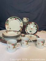 Front view of full Tienshan Magnolia dinnerware set showing plates, bowls and mugs