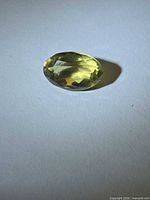 Top view of oval lemon citrine showing faceting and color