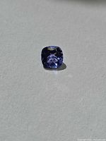 Face-up view of tanzanite showing cushion cut and color