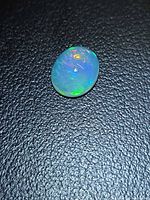 Front view of oval jelly opal showing play-of-color