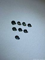 Eight small round faceted sapphires displayed on white background