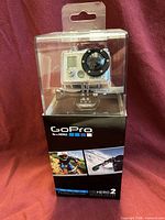 Front view of sealed retail box showing camera in waterproof housing