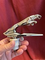 Side view of chrome Jaguar leaper ornament showing mounting hardware