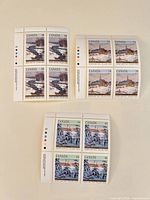 Overview showing three Canadian stamp blocks of four with selvage